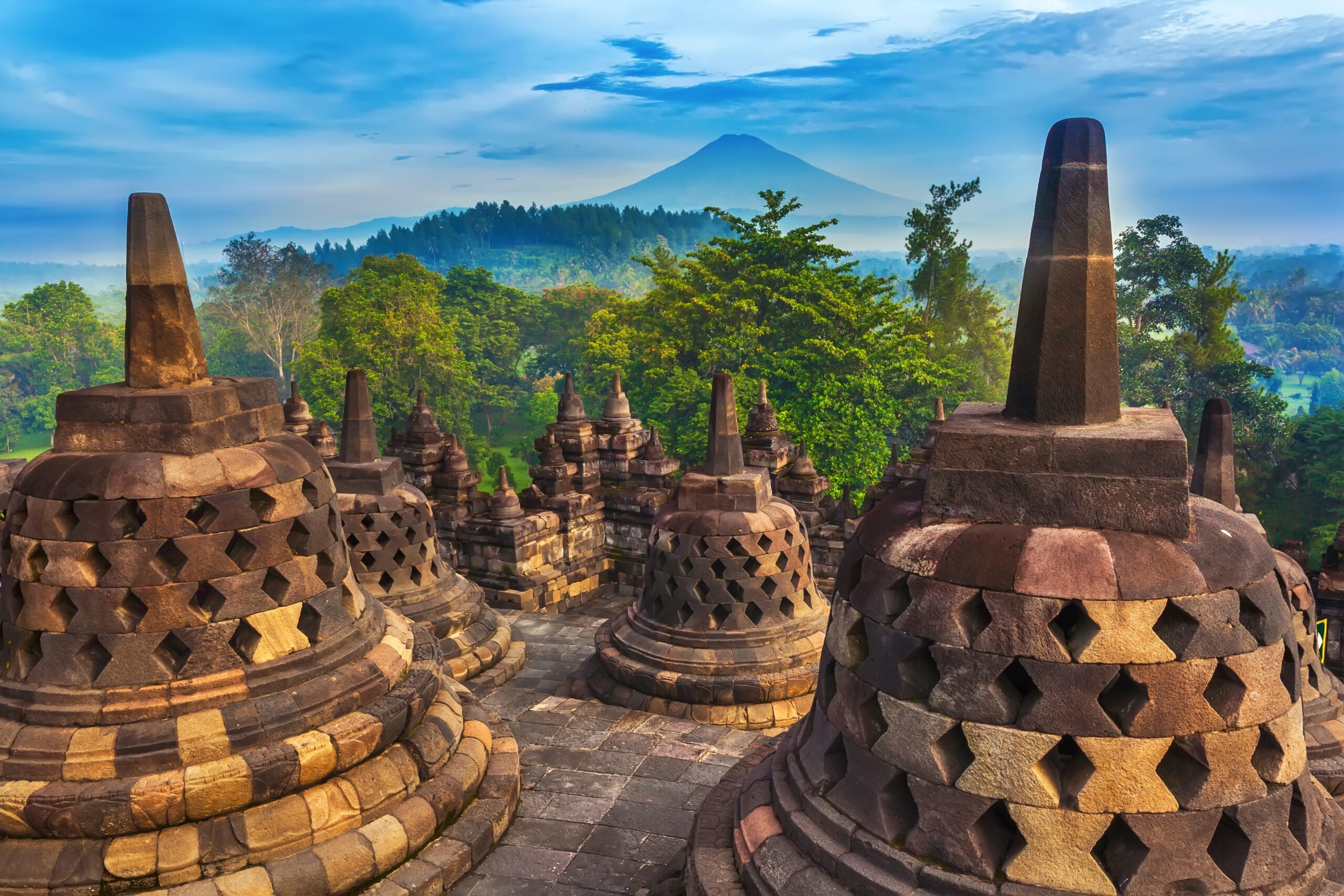 Ancient Buddhist temple stupas at Borobudur during a misty sunrise