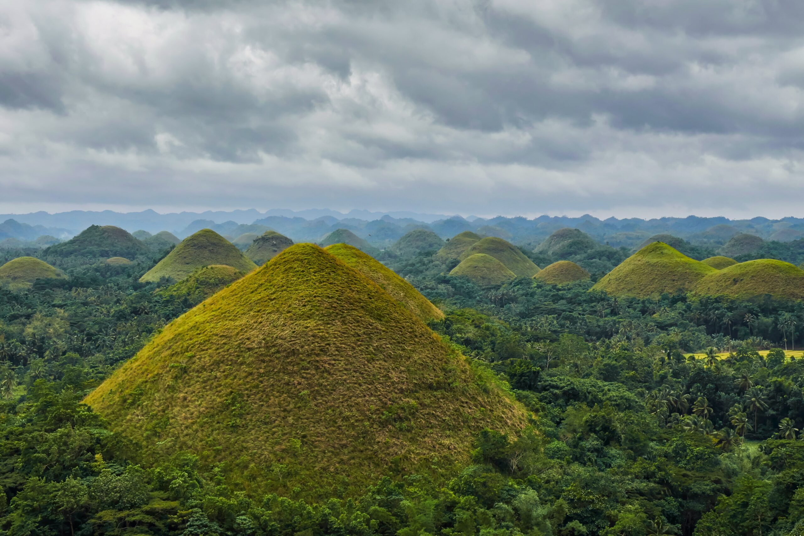 Aerial view of numerous hills on a cloudy day