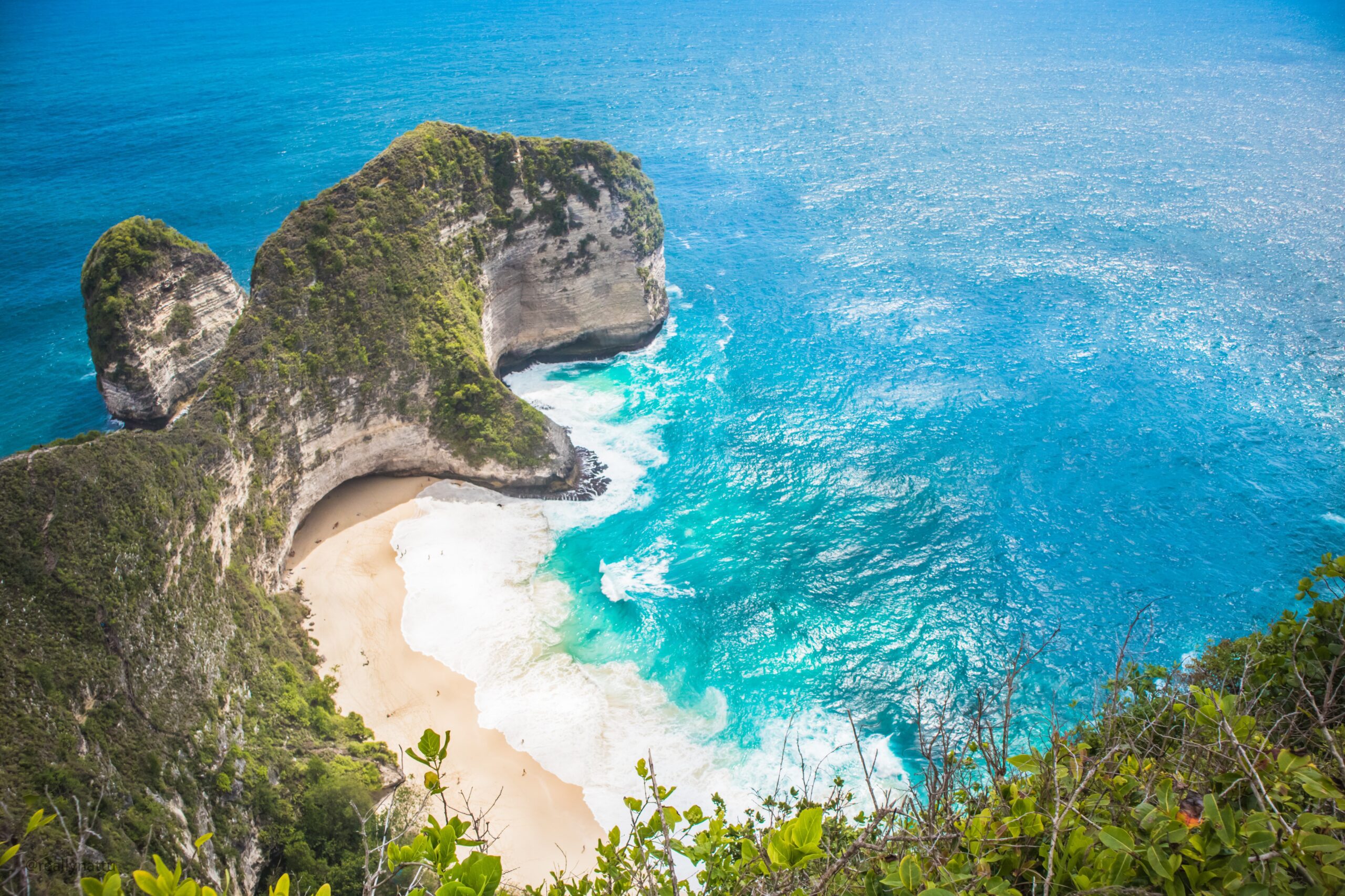 White sand beach, cliffs and blue sea seen from above