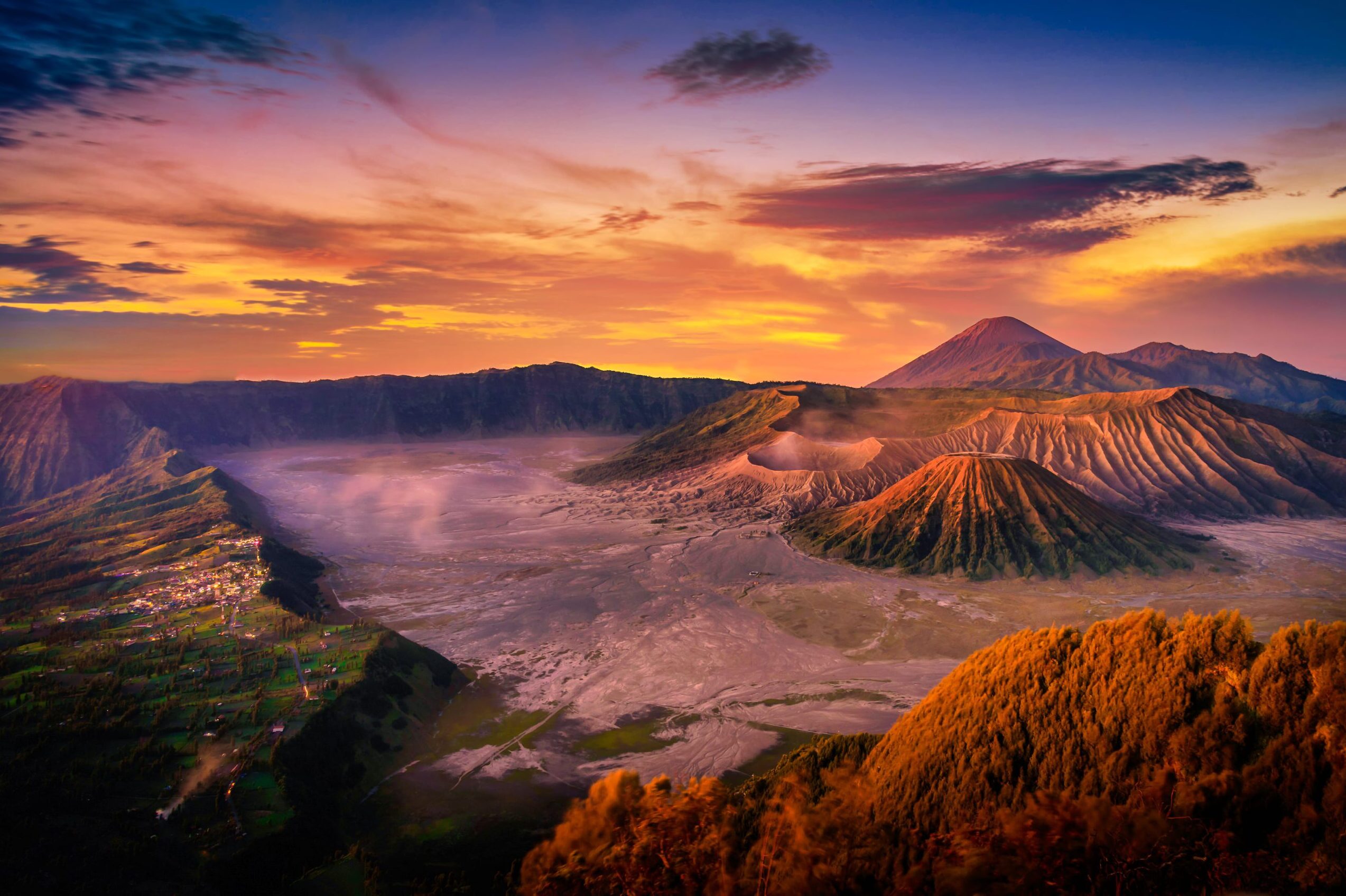 Colorful sunrise view of volcanoes over the clouds