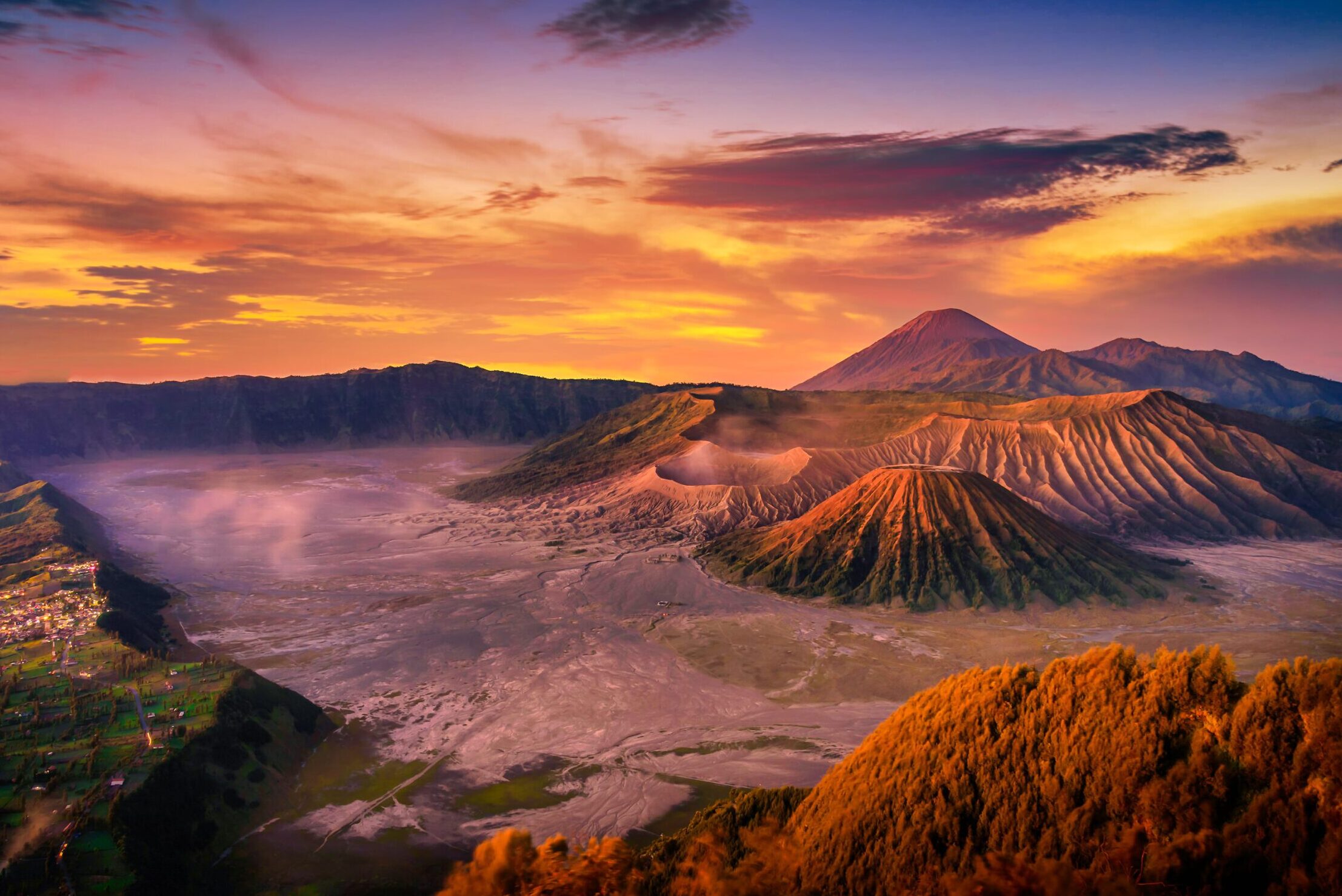 Colorful sunrise view of volcanoes over the clouds