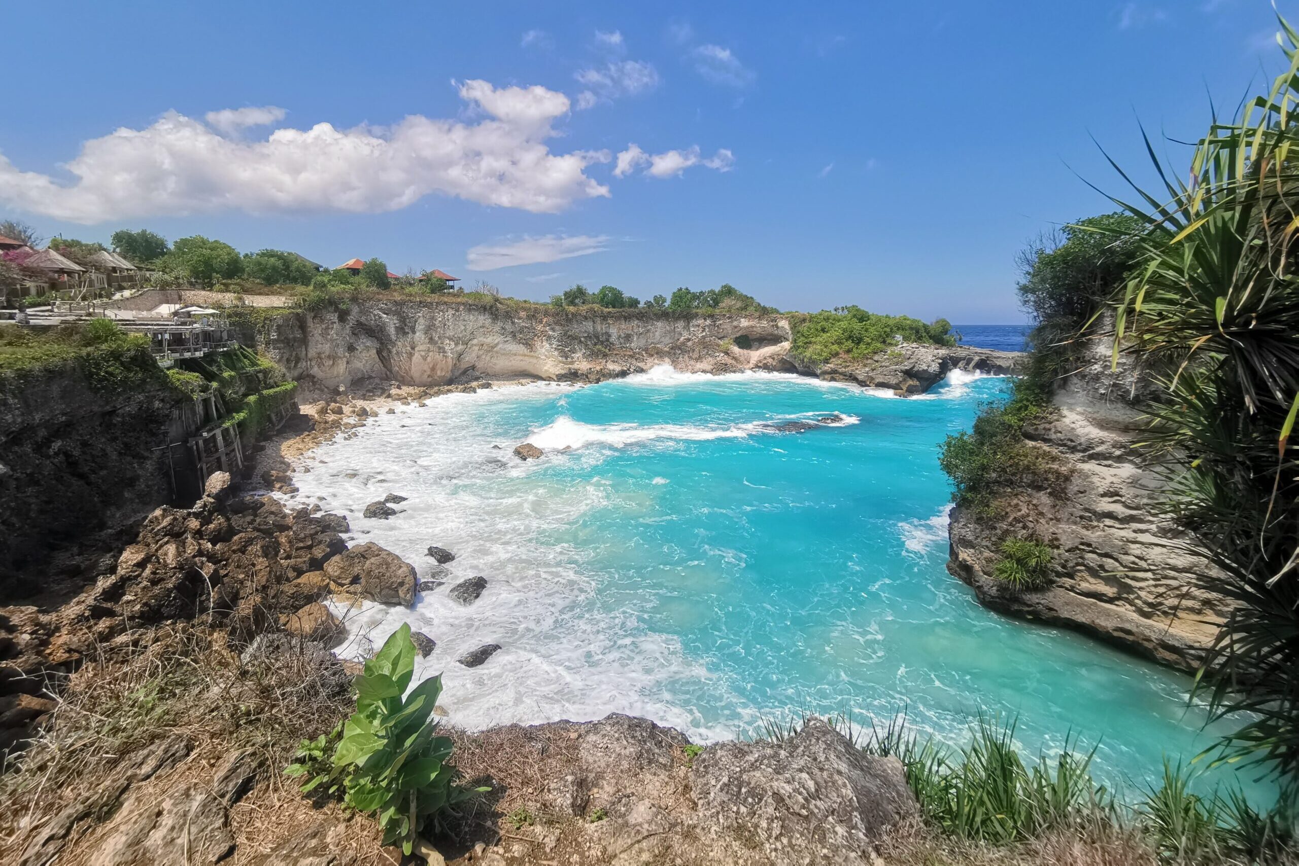 Sea lagoon surrounded by rocky cliffs during day time