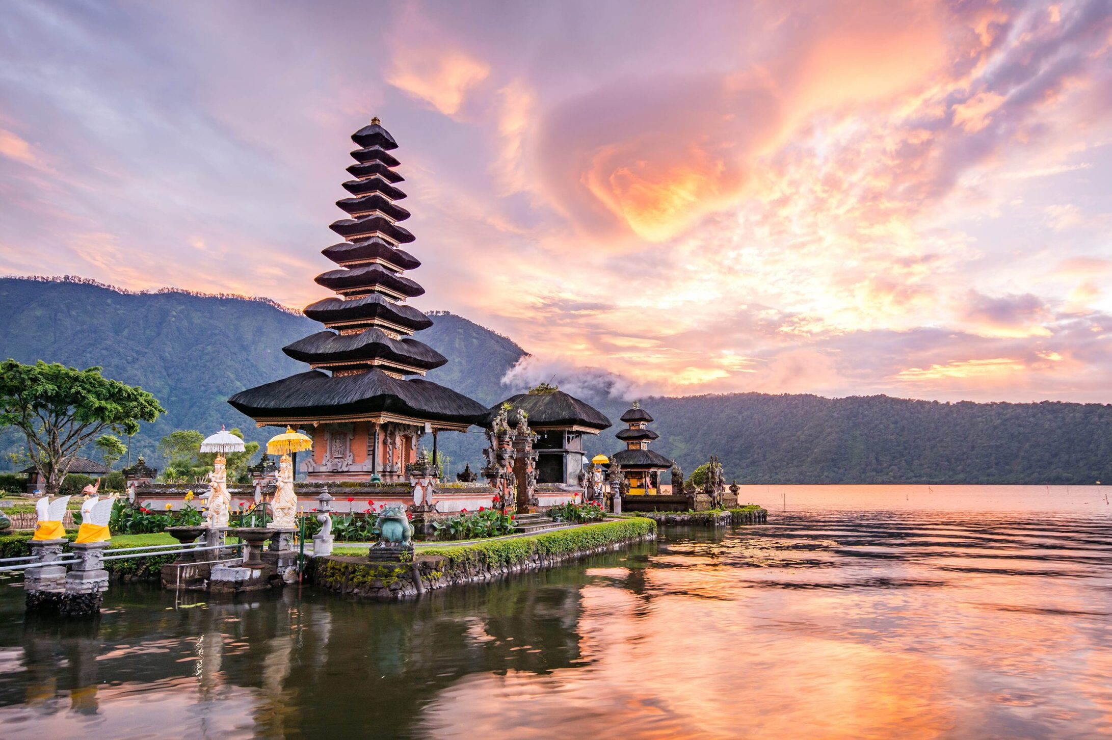 Balinese Hindu temple on a lake at sunset